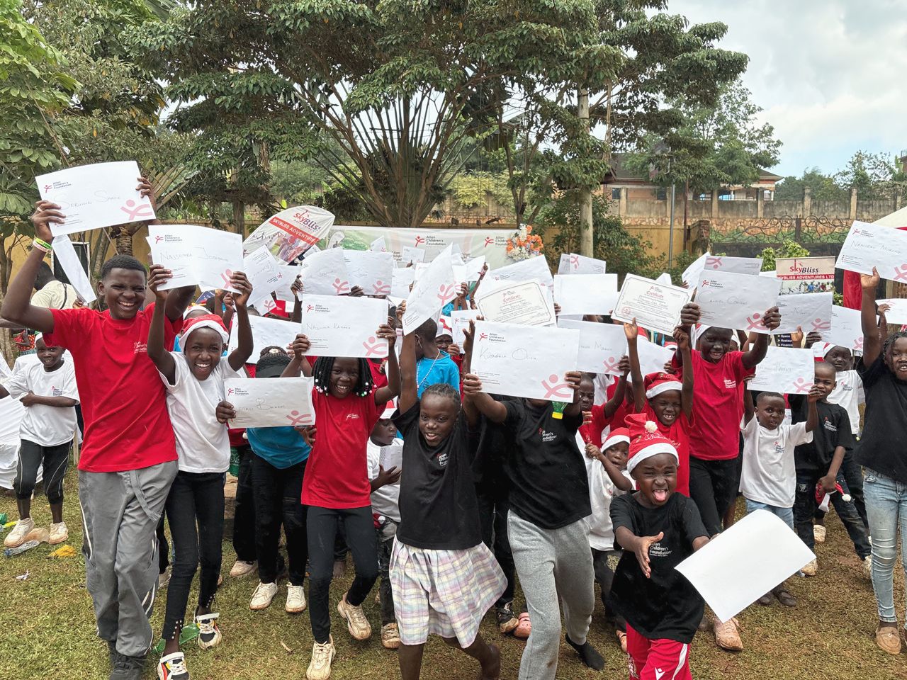 Children proudly holding their certificates
